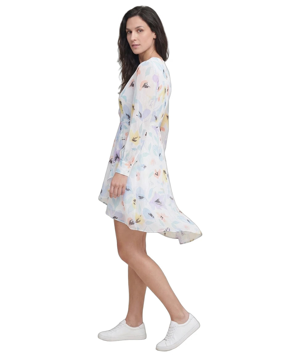 Woman wearing a floral Calvin Klein dress on a white background