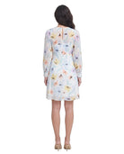 Woman wearing a floral Calvin Klein dress on a white background
