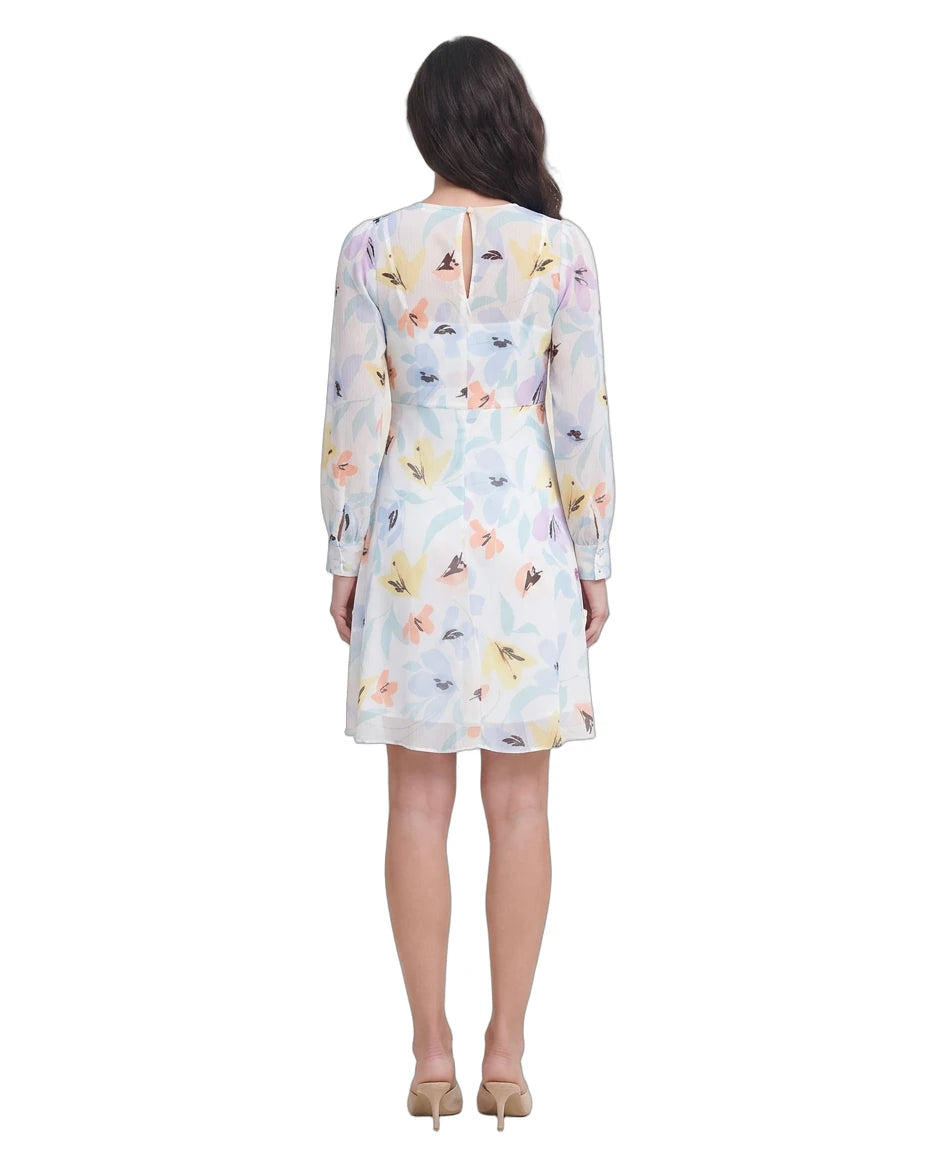Woman wearing a floral Calvin Klein dress on a white background