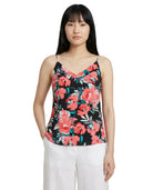 Woman wearing a floral camisole top on a white background