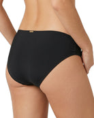 black calvin klein bikini bottom worn by a person on a white background