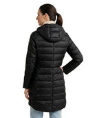Woman wearing a black Calvin Klein puffer coat on a white background