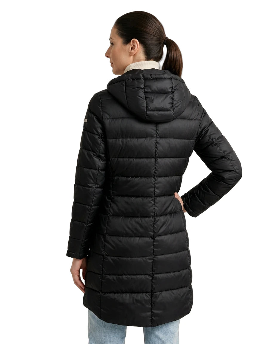 Woman wearing a black Calvin Klein puffer coat on a white background