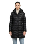 Woman wearing a black Calvin Klein winter coat on a white background