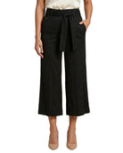 Black Calvin Klein wide-leg pants with a belt worn by a person on a white background