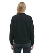 Woman wearing a Calvin Klein black sweatshirt with a brand logo on a white background