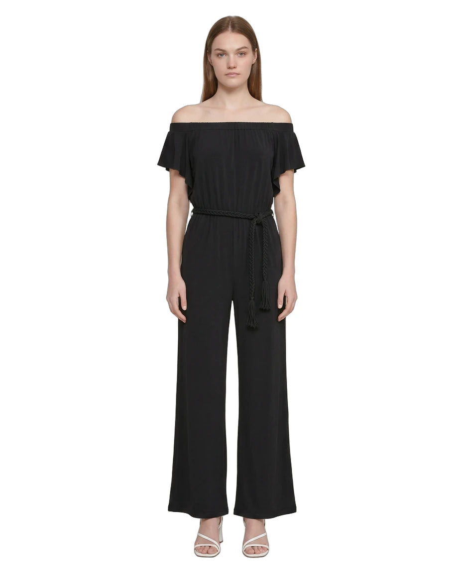 Woman wearing a Calvin Klien black off-shoulder jumpsuit on a white background