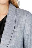 Close-up of a gray checkered Calvin Klein  blazer on a person with a blurred background