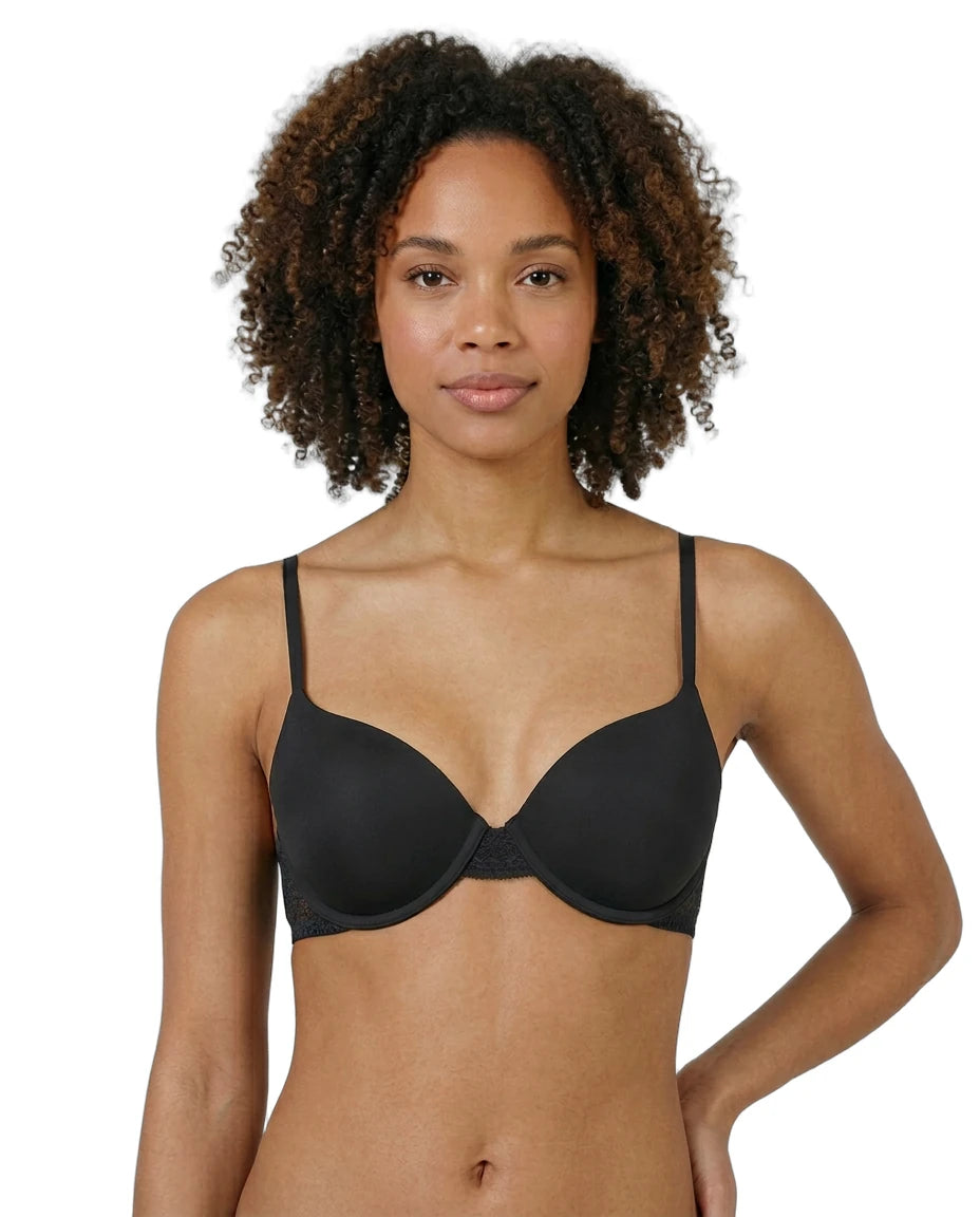 Woman wearing a black Calvin Klein bra on a white background