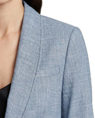 Close-up of a blue Calvin Klein blazer with a pocket on a white background