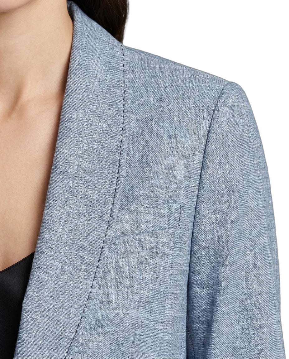 Close-up of a blue Calvin Klein blazer with a pocket on a white background
