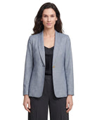 Woman wearing a light blue Calvin Klein  checkered blazer over a black top on a white background