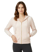 Woman wearing a Calvin Klein light pink hoodie on a white background