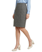 Person wearing a gray checkered skirt with a light blue shirt on a white background
