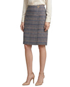 Person wearing a Calvin Klein plaid skirt on a white background