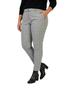 Person wearing Calvin Klein gray checkered pants and black boots on a white background