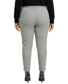Calvin Klein gray checkered pants worn by a person on a white background