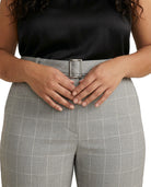 Person wearing Calvin Klein gray checkered pants with a black top on a white background
