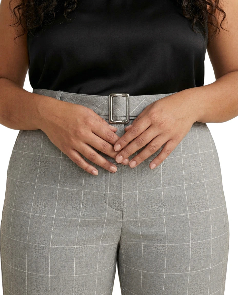 Person wearing Calvin Klein gray checkered pants with a black top on a white background