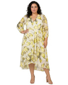 Woman wearing a Calvin Klein floral dress on a white background