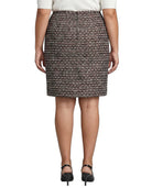 Person wearing a Calvin Klein patterned skirt on a white background