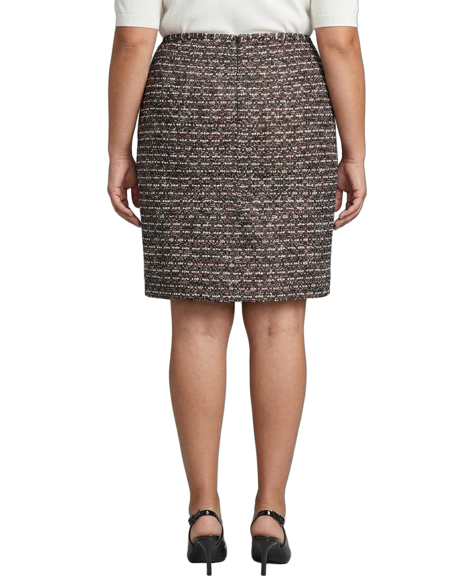 Person wearing a Calvin Klein patterned skirt on a white background