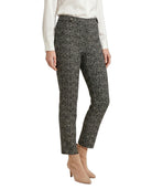 Person wearing black and white patterned Calin Klein pants on a white background