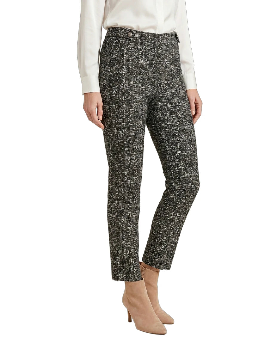 Person wearing black and white patterned Calin Klein pants on a white background