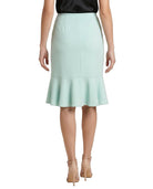 Light blue Calvin Klein skirt worn by a person on a white background