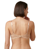 Woman wearing a beige Calvin Klein bra on a white background