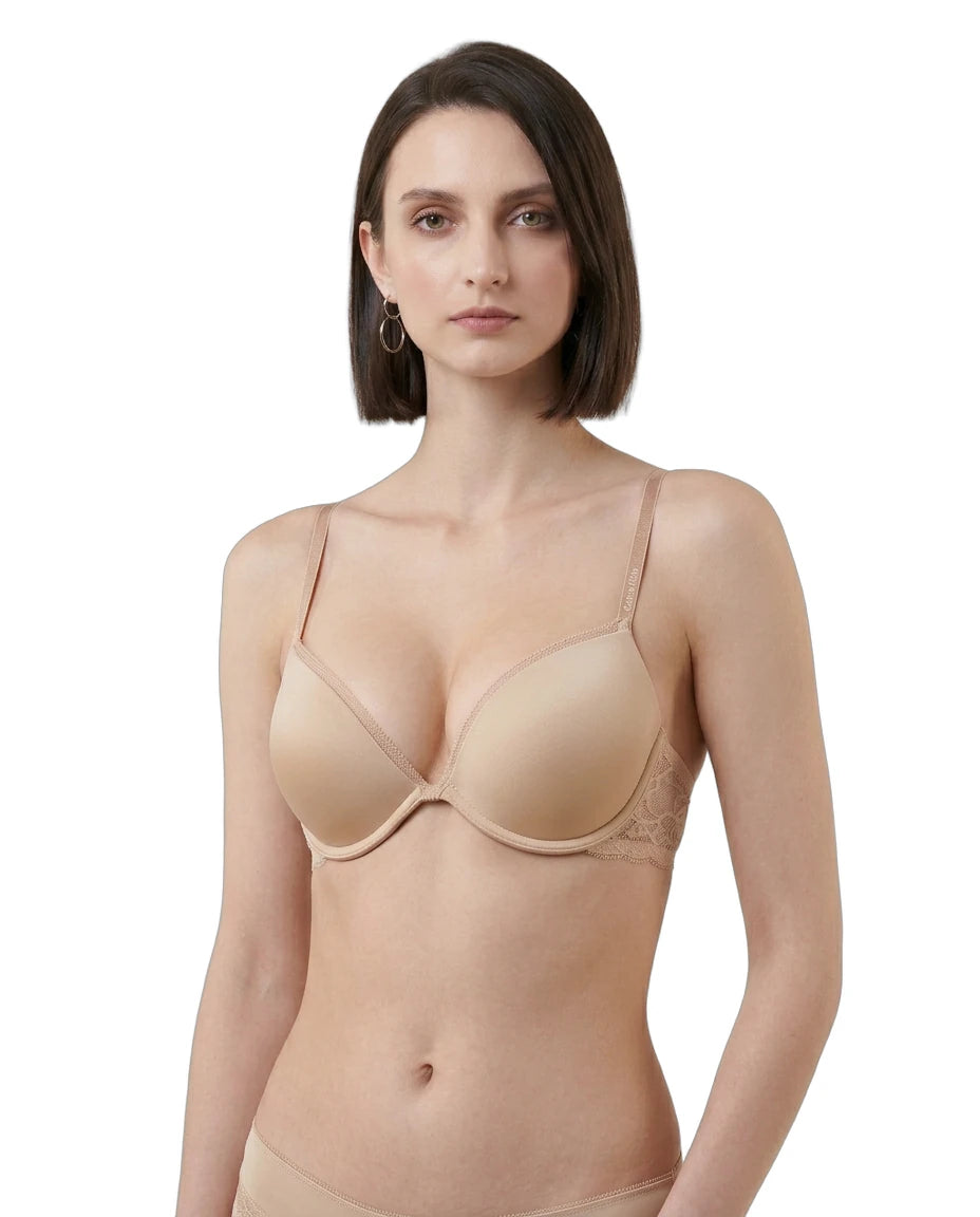 Woman wearing a beige Calvin Klein bra on a white background