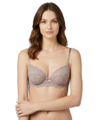 Woman wearing a beige Calvin Klein bra on a white background