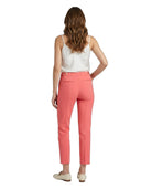 Woman wearing coral Calvin Klein pants and a white top on a white background