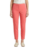 Person wearing coral Calvin Klein pants on a white background