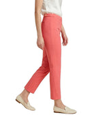 Person wearing Calvin Klein coral pants and white top on a white background