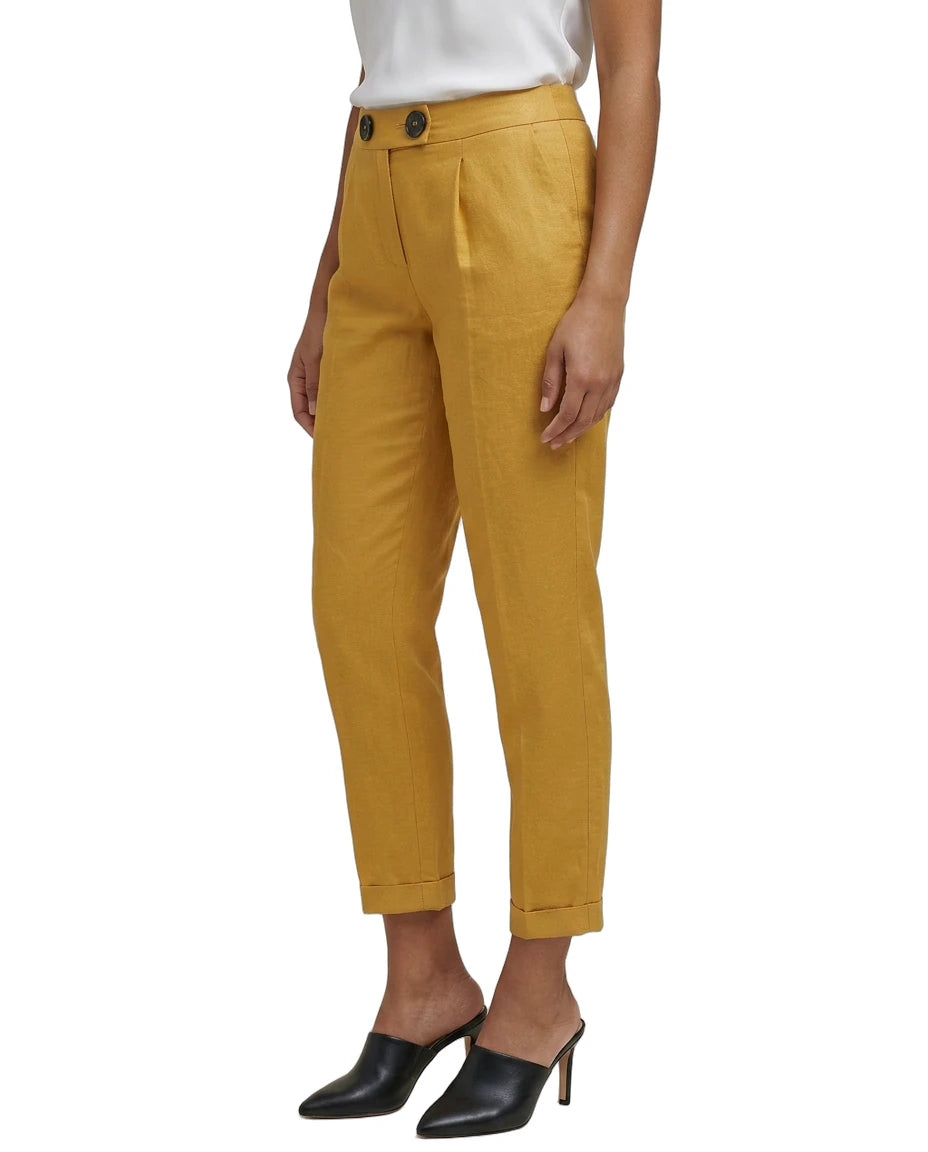 Mustard yellow Calvin Klein pants worn by a person on a white background