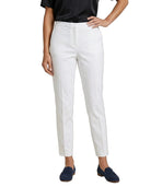 Person wearing white Calvin Klein pants on a white background