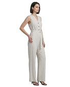 Woman wearing a sleeveless striped Calvin Klein jumpsuit on a white background