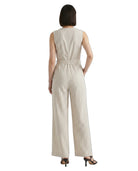 Woman wearing a striped Calvin Klein jumpsuit on a white background