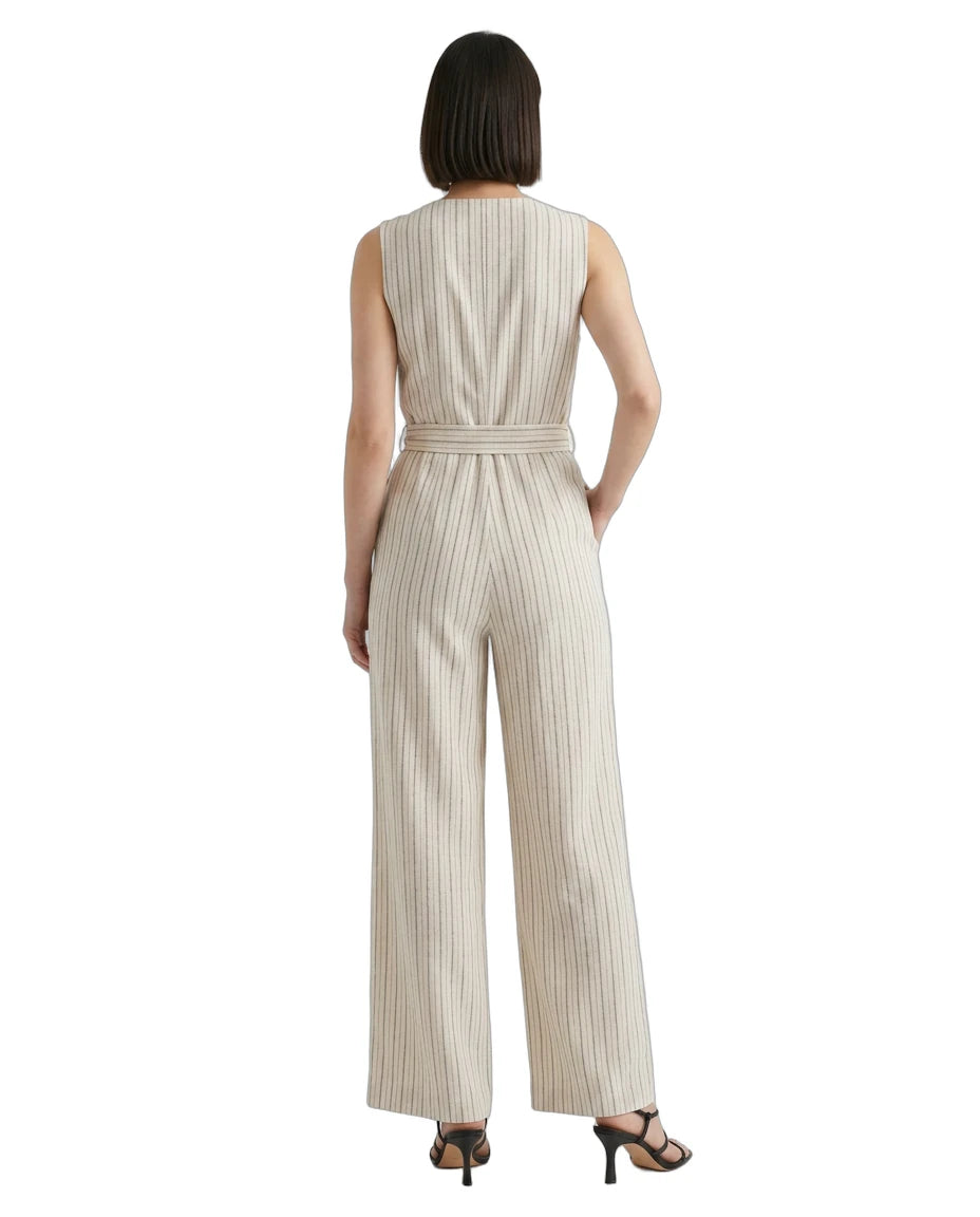 Woman wearing a striped Calvin Klein jumpsuit on a white background
