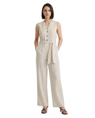 Woman wearing a beige striped Calvin Klein jumpsuit on a white background