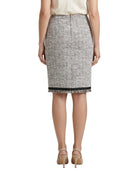Person wearing a patterned Calvin Klein skirt on a white background