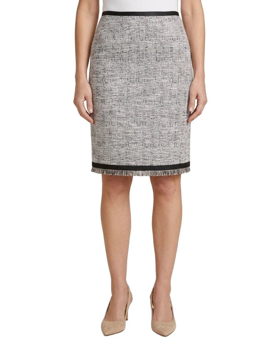 Person wearing a black and white patterned Calvin Klein skirt on a white background