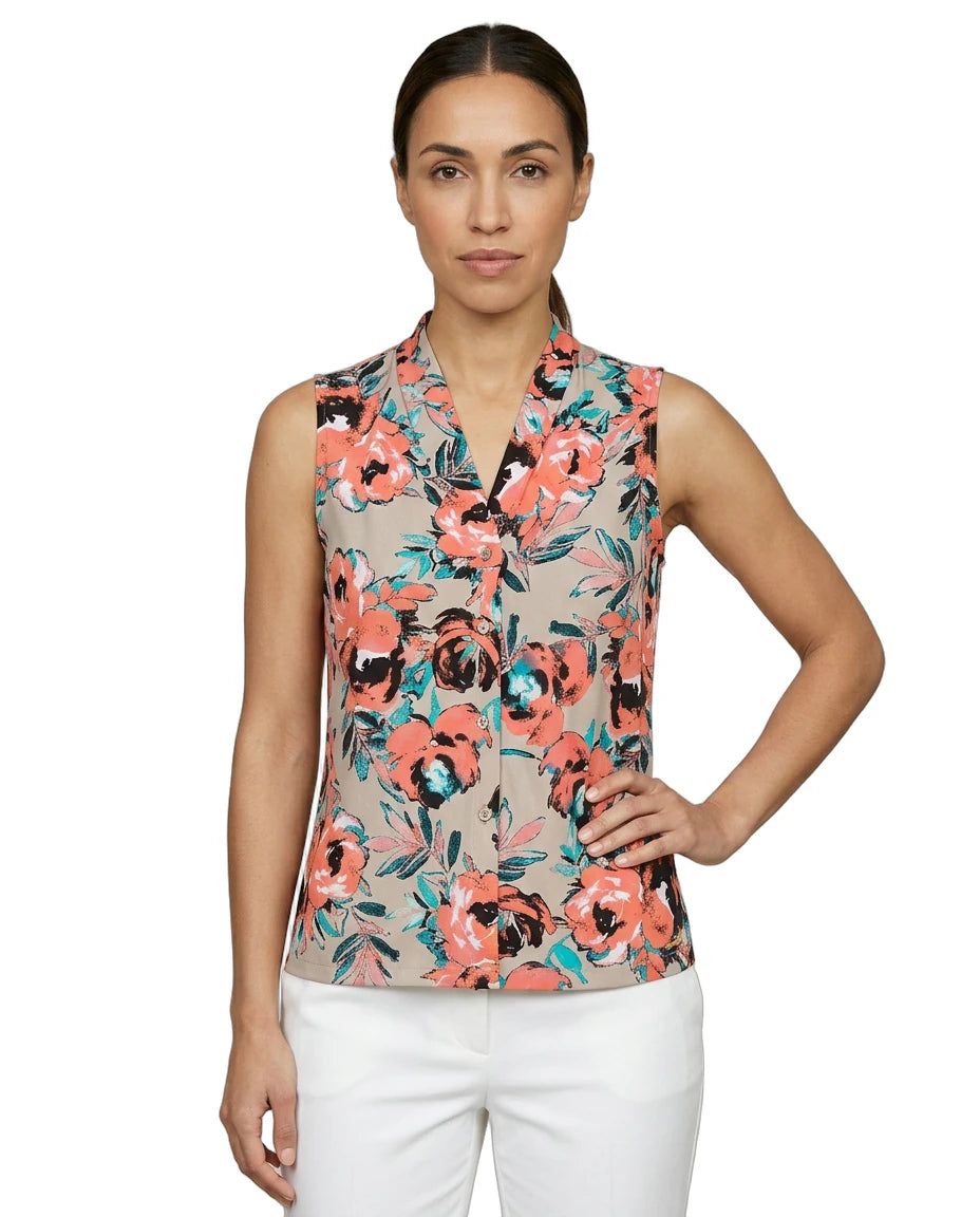 Woman wearing a sleeveless floral Calvin Klein blouse with a white background