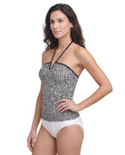 Woman wearing a black and white patterned Calvin Klein tankini top on a white background