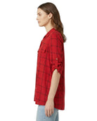 Woman wearing a red plaid Calvin Klein shirt on a white background