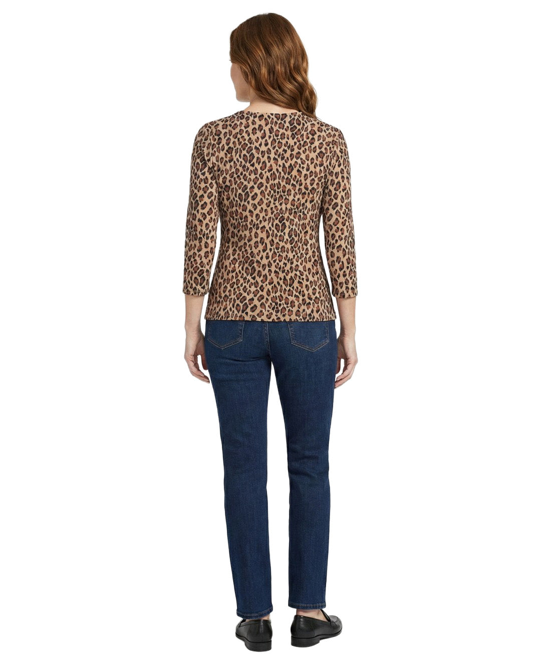 Woman wearing a leopard print top and blue jeans on a white background