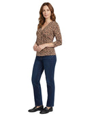Woman wearing a leopard print top and blue jeans on a white background