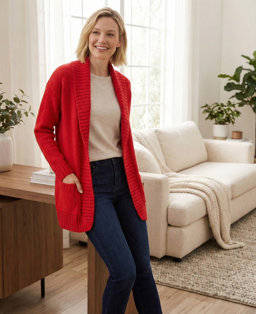 Woman wearing a red cardigan in a living room setting