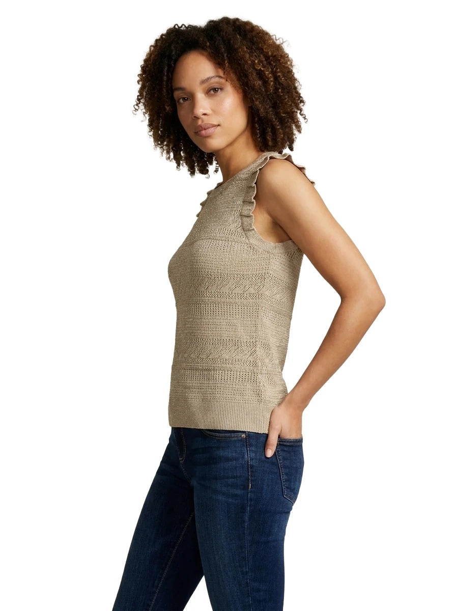 Side profile view of a woman wearing the INC International Concepts sleeveless beige knit top showing the pleated ruffle trim along the shoulder armhole.
